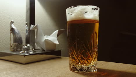 Cold-beer-in-a-glass-with-air-bubbles-and-foam,-close-up