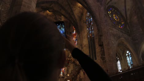 Over-The-Shoulder-Shot-of-Tourist-Taking-Picture-of-Ceiling-in-Cathedral