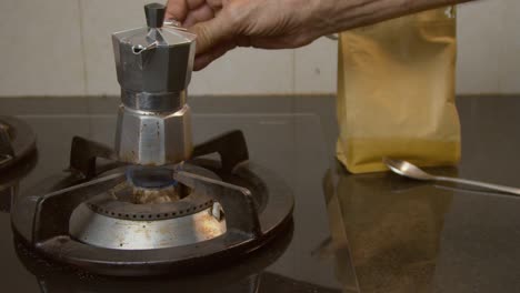 Small-moka-coffee-pot-being-placed-on-gas-stove