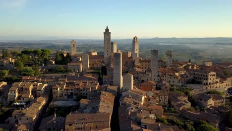 San-Gimignano-Italy-with-Torre-Grossa-and-Duomo-di-San-Gimignano-visible,-Aerial-drone-flyover-shot