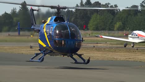 HELICOPTER-TAKING-OFF-FROM-AIRPORT-RUNWAY