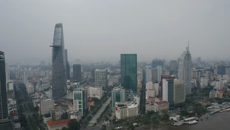 tracking-high-aerial-view-of-Saigon-River-waterfront-areas-and-financial-district-of-Ho-Chi-Minh-City,-Vietnam