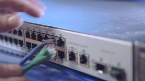Network-engineer-securing-Ethernet-cables-into-switch