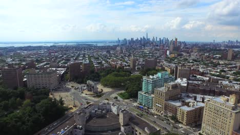 Aerial-view-of-Manhattan-skyline-flying-over-Grand-Army-Plaza-circle-traffic-4K