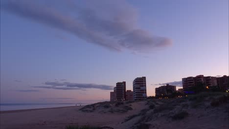 Timelapse-of-the-buildings-and-dunes-of-Arenales-del-Sol,-Costa-Blanca,-at-the-sunset