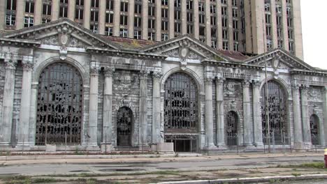 Front-of-Michigan-Central-Station-with-fence-and-broken-windows,-Detroit,-Michigan,-USA