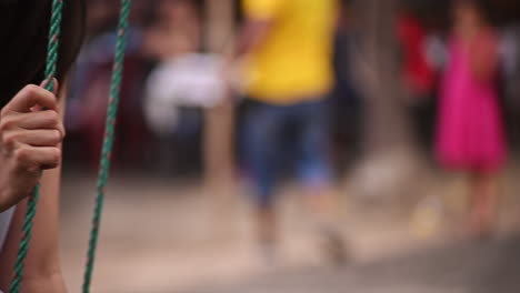 Close-up-of-a-young-girl-on-a-swing-made-of-wood-and-rope