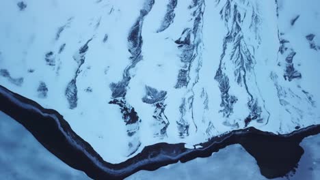 aerial-video-of-a-frozen-lake-in-Switzerland,-drone-video-of-the-wintery-weather-in-Europe,-snowy-ground
