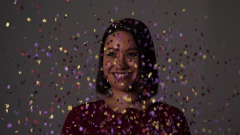 Laughing-young-woman-is-bombarded-with-confetti-from-both-sides---Slow-motion