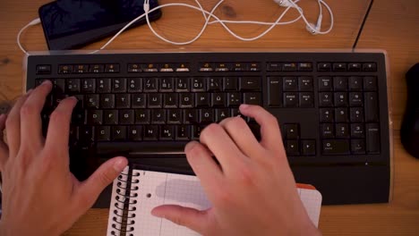 Young-man-is-writting-a-text-on-his-computer-using-a-keyboard-4