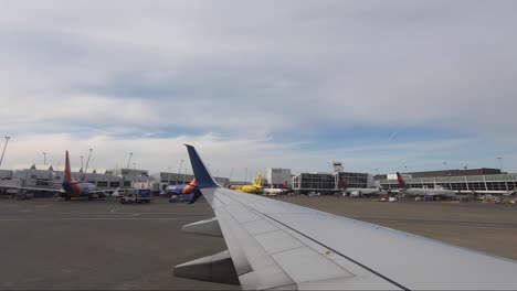 Wing-of-an-airplane-waiting-on-the-ground-in-the-SEA-airport,-Seattle,-Washington