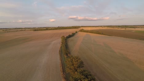 Slowly-panning-360-degrees-to-show-an-open-landscape-of-farmland-ending-with-a-shot-of-a-beautiful-summer-sunset