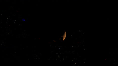 Urban-half-moon-time-lapse-hiding-behind-buildings