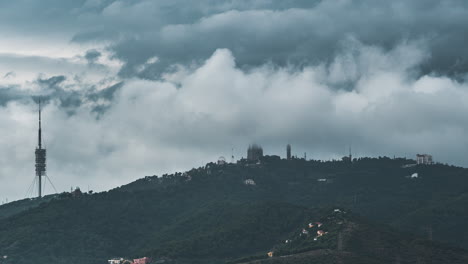 Temple-of-the-Sacred-Heart-of-Jesus-timelapse-on-Tibidabo-Mountain-in-Barcelona-in-clouds,-Catalonia,-Spain