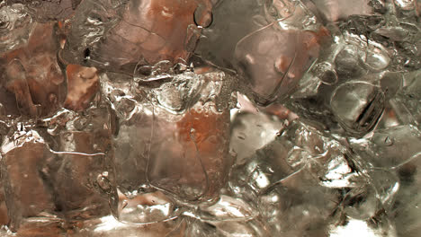 A-glass-full-of-ice-cubes-gradually-being-filled-with-ice-tea