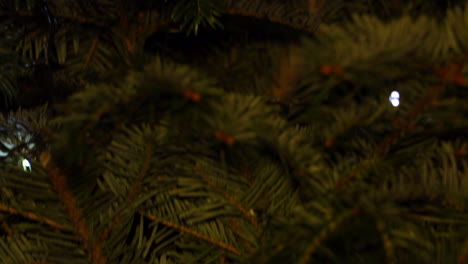 Tilt-down,-Close-Up-of-Christmas-Tree-with-LED-String-Lights,-Pulsing-and-Flashing