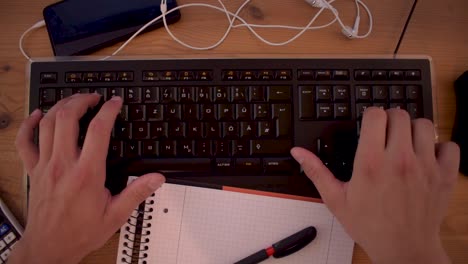 Young-man-is-writting-a-text-on-his-computer-using-a-keyboard-5