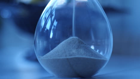 Hourglass-sand-falling-in-slow-motion-blue