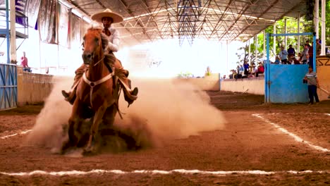 Charros,-Mexican-cowboys-performing-tricks-during-a-Charreada,-a-horse-rider-competition
