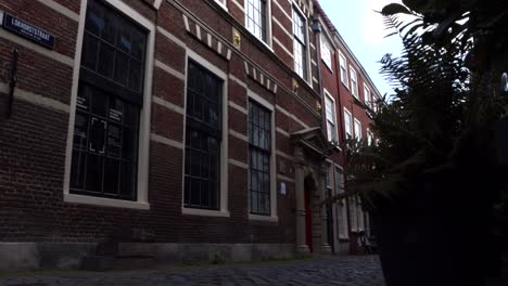 Slide-shot-of-cobbled-alley-and-Latin-School-in-Leiden,-Netherlands,-where-famous-Dutch-painter-Rembrandt-got-his-first-drawing-lessons