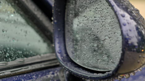 Close-up-of-side-mirror-in-the-rain