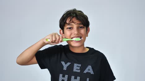 Portrait-of-cheerful-boy-washing-teeth-isolated-on-white-background