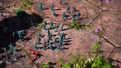 A-shadow-of-a-child-in-a-garden-playing-with-toy-soldiers