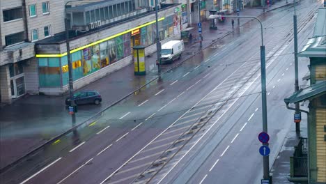 Busy-street-early-morning-aerial-timelapse-with-pedestrians,-cars,-trams-and-buses