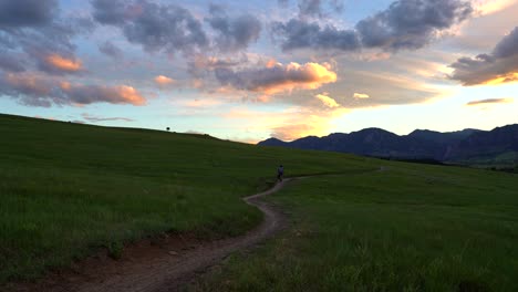 Mountain-biker-riding-in-trail-at-sunset