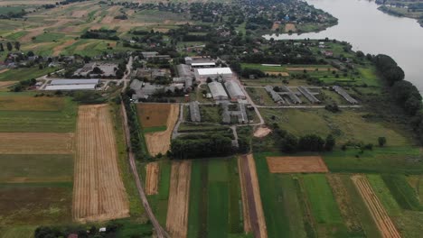 Aerial-View-of-Industrial-Farm-Facility-Surrounded-by-Fields-and-River