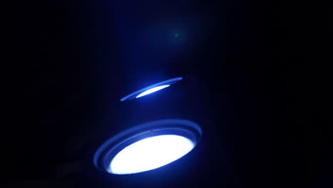 A-pair-of-blue-spotlights-illuminate-theatrical-smoke