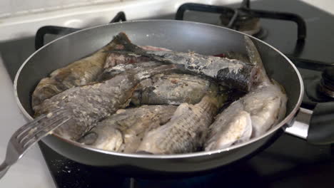 Sea-fish-is-fried-in-a-frying-pan-for-lunch-with-close-up-view