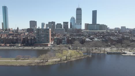 Boston,-Massachusetts.-Riverfront-against-cityscape.-Establisher-traveling-shot