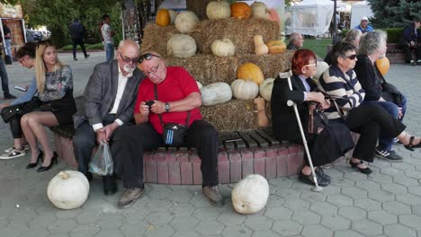 Elderly-people-sitting-in-front-of-a-pumpkin-exhibition
