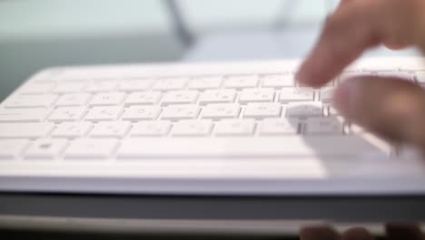 Man-typing-on-keyboard,-hand-close-up