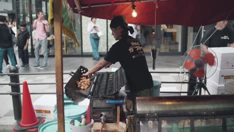 A-Japanese-Street-Food-Vendor-Making-Food-During-The-Famous-Gion-Matsuri-Festival-In-Kyoto,-Japan---Medium-Shot