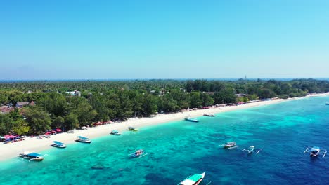 Vivid-colors-of-Balinese-island-coastline-with-tourist-boats-floating-over-blue-azure-sea-water-near-white-sandy-beach