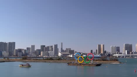 The-iconic-Olympic-rings-situated-in-Tokyo-Bay,-Japan--Wide-shot