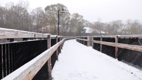 Snow-covered-wooden-bridge-during-fresh-snowfall-1