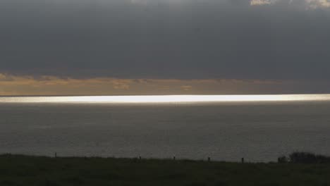 Sunlit-Sea-Horizon-on-Holy-Island-on-a-Cloudy-Day