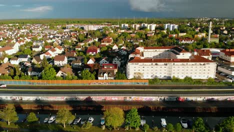Aerial-view-overlooking-the-townscape-of-the-Raunheim-town,-sunny,-summer-evening,-in-Germany---tracking,-drone-shot