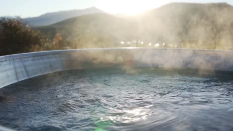 Hot-steaming-hot-tub-bubbling-during-mountain-sunset