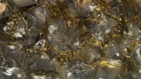 Cocktail-ingredients-are-bleeding-through-the-ice-cubes'-extreme-close-up