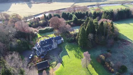 Drone-video-of-a-Scottish-Country-Estate-with-manicured-gardens,-lochs,-rivers,-forests-and-hillside-landscapes