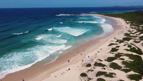 Drone-aerial-view-of-Soldiers-Beach-Surf-waves-coastline-tourism-Norah-Head-Central-Coast-NSW-Australia-4K