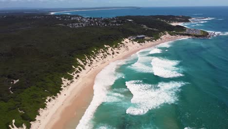 Drone-aerial-view-of-Soldiers-Beach-Surf-Club-waves-and-coastline-Central-Coast-tourism-NSW-Australia-4K