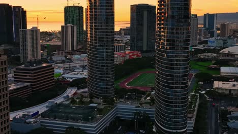 Aerial-footage-of-Oahu's-cityscapes-during-golden-hour