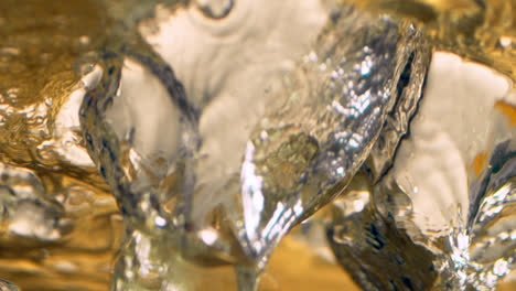 Ice-breaks-through-the-surface-of-a-cold-drink-in-dramatic-slow-motion-1