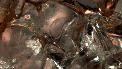 Pouring-Cola-on-ice-cubes-extreme-close-up