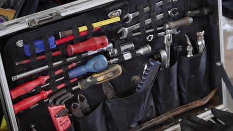 Slow-slide-across-mechanics-tool-box-full-of-wrenches-and-tools-at-race-track